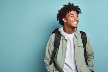 Fictional black man smiling with a backpack. Isolated on a colored background.  Generative AI.