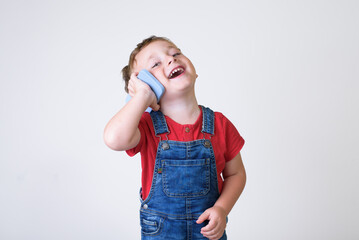 Smiling boy using cell phone isolated in white studio