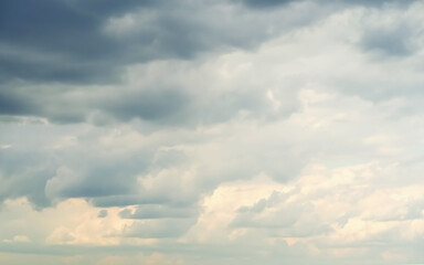 blue and gray fluffy clouds in the evening sky, beautiful natural background