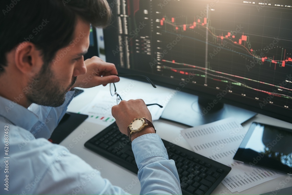 Aufkleber time to trade. bearded male trader looking at watch on his hand while working with data and charts o