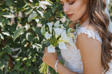 cropped portrait of the bride with a bouquet. A beautiful young bride holds a wedding bouquet in...
