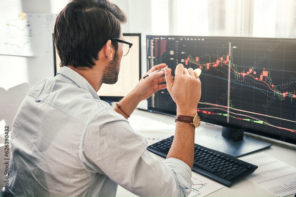 Poster successful trading. back view of young bearded trader in formal wear pointing on the data on compute