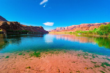 The Colorado River reflects the rocks