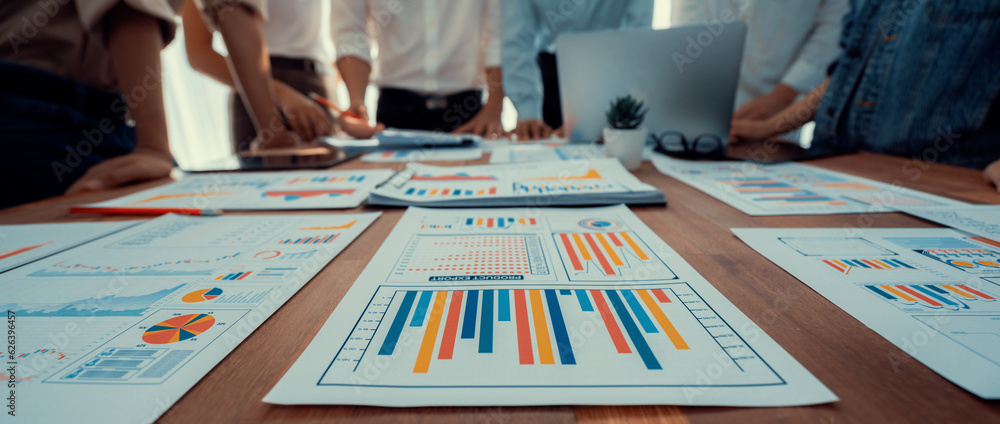 Poster focus panorama shot of chart and graph paper with blur analyst team utilize bi fintech to analyze fi