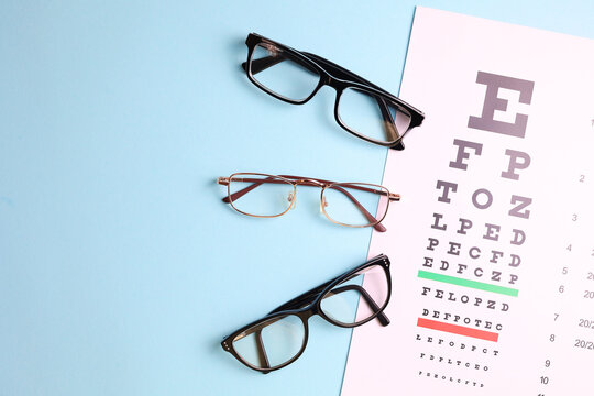 vision correction glasses on the background of a vision test table with space for text