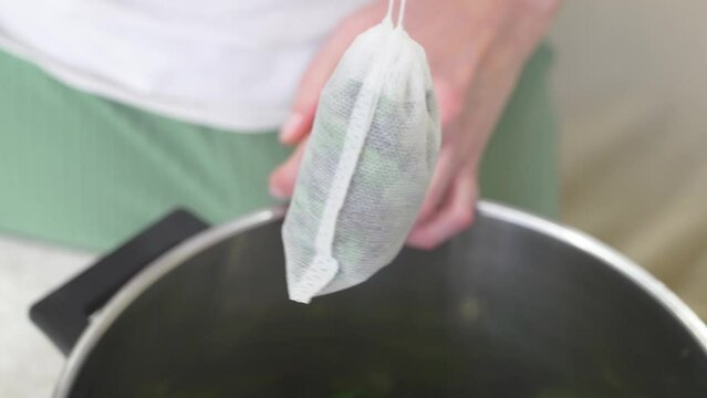 The process of packing the collection of tea herbs in convenient portioned bags.