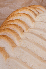 Sliced white bread with brown crust closeup.