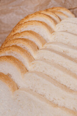 Sliced white bread with brown crust closeup.