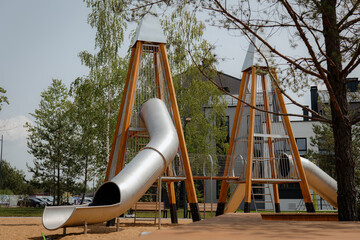 Сhildren's modern wooden playground in the middle of a forest or park