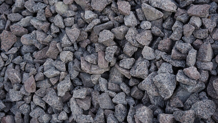 Crushed stone mounds.Grey crushed stones in close up,Versatile building material for...