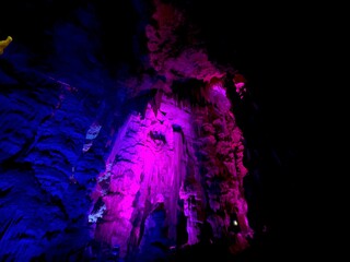 famous artistically colorfully illuminated St. Michael's Cave in the Rock of Gibraltar, British...