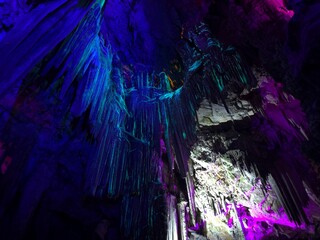 famous artistically colorfully illuminated St. Michael's Cave in the Rock of Gibraltar, British...