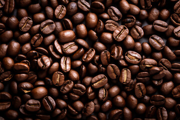 Fototapeta premium Roasted coffee beans background, top view image of coffee beans