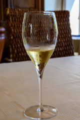 Tasting of grand cru sparkling white wine with bubbles champagne by old champagne house in grand cru wine producer small village Ambonnay, Champagne, France