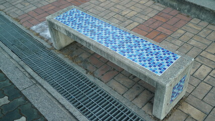 Blue mosaic tile pattern stone bench
