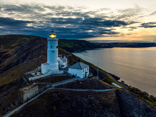 Sunset over Start Point Lighthouse from a drone, Trinity House and South West Coast Path, Devon, England