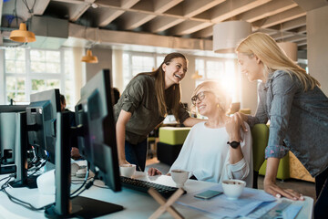 Young women working on a project together in a startup company office