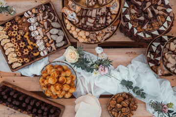 Top view of dessert setup, wooden background, natural wedding