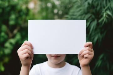 Kid's Hands Holding Blank Horizontal White Card Mockup with Nature Background, Empty Paper Poster Template, Perfect for Invitations, Greetings Product Presentation. Generative AI