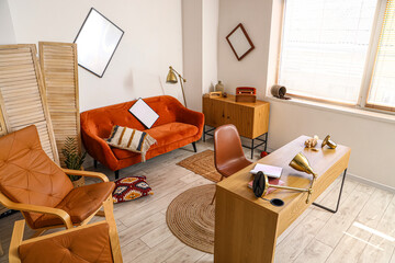 Fototapeta na wymiar Modern workplace and sofa in messy office