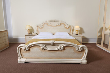 Stylish bedroom interior with comfortable bed and lamps on bedside tables