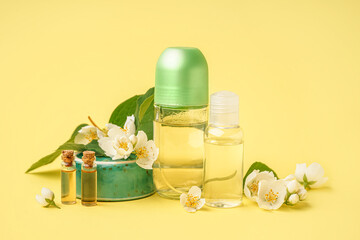 Composition with cosmetic products and beautiful jasmine flowers on yellow background