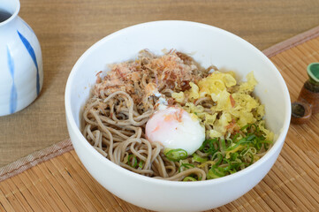 Bukkake soba is Japanese chilled buckwheat noodles, served with a soy-based broth and toppings like bonito flakes, a soft-cooked egg, and scallions.