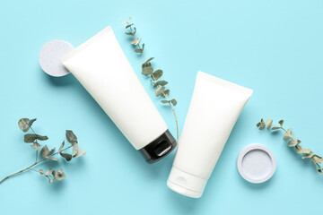Composition with cosmetic products and eucalyptus branches on color background