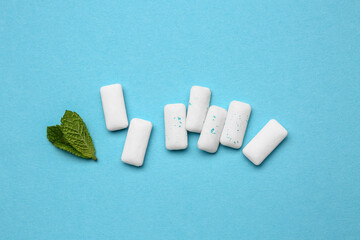 Fresh chewing gums with mint on blue background