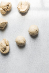 Bread dough divided into portions, process of making Swedish cinnamon buns or homemade Kanelbullar