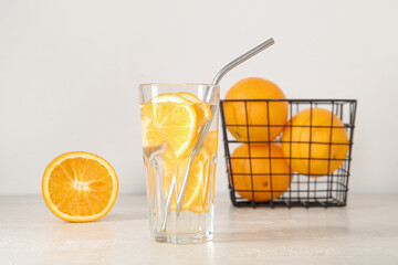 Glass of infused water with orange on white background