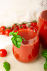 Glass of tasty tomato juice on white background