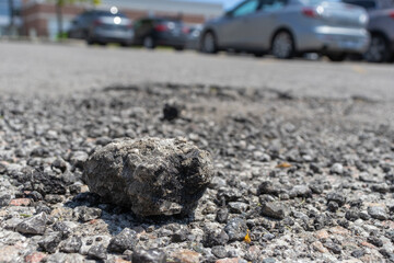 Small rock on road - rough texture close up background. Taken in Toronto, Canada.