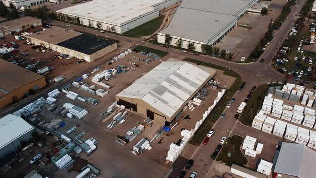 Revealing drone shot of the warehouse with construction supplies in Calgary, Alberta.