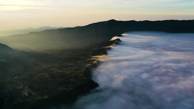 Aerial hyperlapse of fog moving in a valley, sunrise in Tengger, Java, Indonesia
