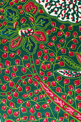 top view of red and green ankara fabric, flatlay of nigerian wax cloth, red and green ankara material on a table