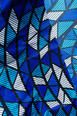 top view of blue and white ankara fabric, selective focus of nigerian wax cloth, rumpled blue and white ankara material