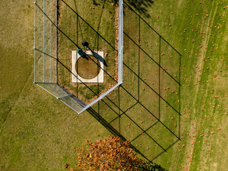 An aerial view of a child and his grandmother playing at a park in autumn