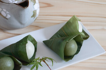Sasa dango  is dark green dango with a flavor of Japanese mugwort wrapped in fresh bamboo leaves. 