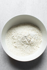 All purpose flour in a white bowl, baking flour in a large bowl