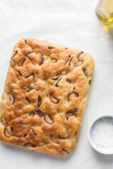 Top view of homemade onion focaccia on a white background, Flatlay of focaccia with red onion topping, fresh homemade focaccia bread