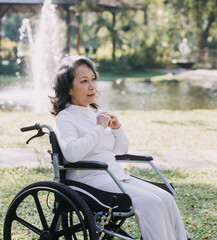 young asian physical therapist working with senior woman on walking with a walker