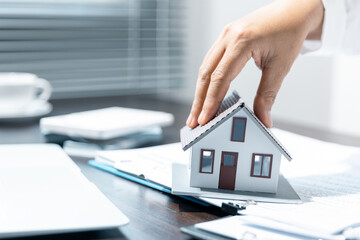 Single family house, concept of real estate, Sales manager or real estate agent prepares to hand over the keys and the house together with the insurance to the customer.