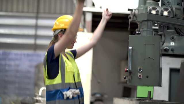 Industry engineer woman inspect control cabinet machine in industrial factory. mechanical technicians female checking or working with controller machine. happy and excited to dancing after work finish