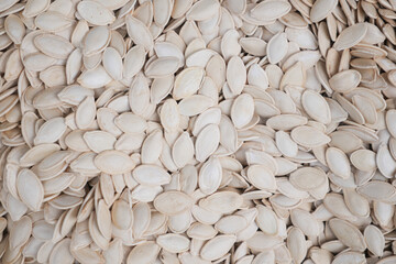 White raw pumpkin seeds as background