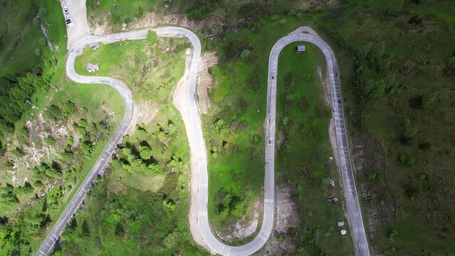 Top down aerial shot of curvy twisted mountain road in Passo Giau, Italy. Static