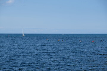
sailboat and kayaks on the big lake