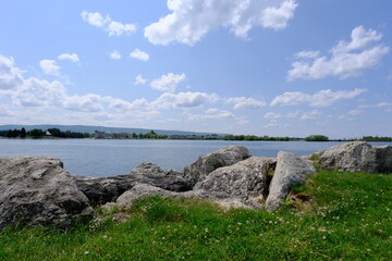 
shore and lake view with blue mountains at the distance