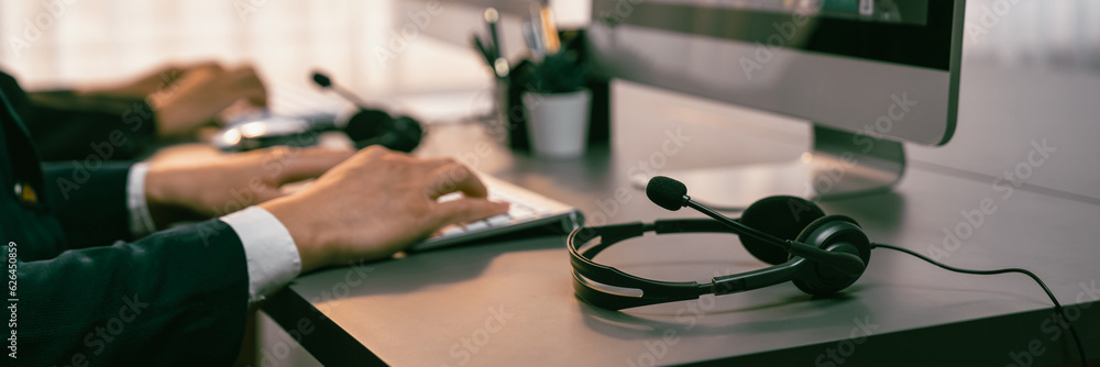 Aufkleber panorama focus headset on call center workspace desk with blur background of operator team or telesa