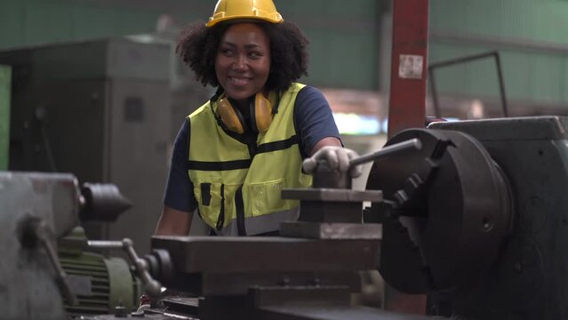 African American tired worker woman hard working sweat dirty gloves repair old machine in industrial manufacturing factory. black female labor mechanic engineer maintenance and check. hot weather